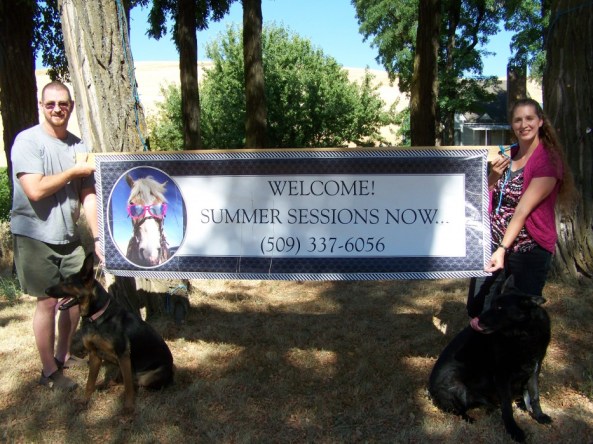 Picture of us holding up a banner about our summer program.