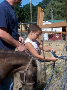 Picture of boy learning horseman's safety knot in a session with Trigger.