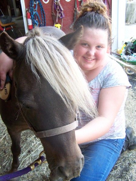 Picture of a girl enjoying taking care of Trigger.