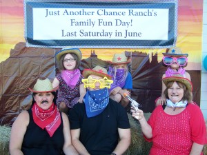 Picture of a family of 6 dressing up in western play clothes.